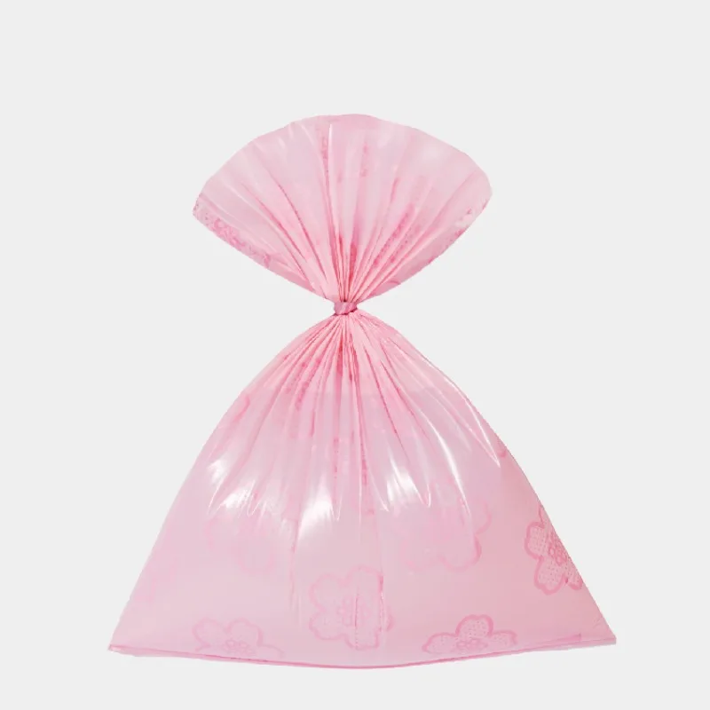 Sac à déjections rose noué au sommet, motif fleur discret