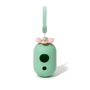 Distributeur de sacs à déjections vert menthe à fleur rose, vue de face avec sa dragonne