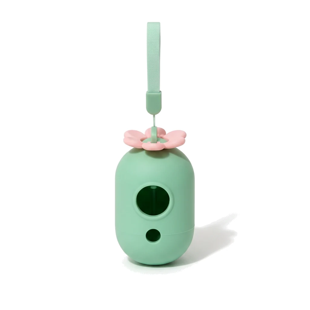 Distributeur de sacs à déjections vert menthe à fleur rose, vue de face avec sa dragonne